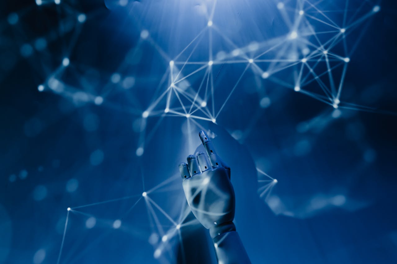 services-03 A robotic hand reaching into a digital network on a blue background, symbolizing AI technology.