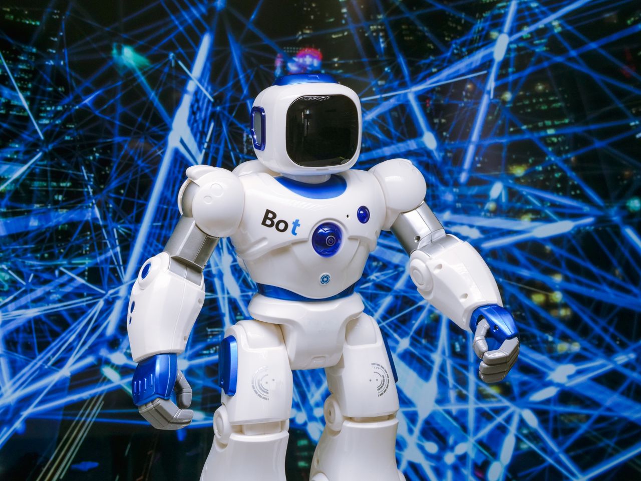about-01 Advanced humanoid robot with glowing blue accents in a digital network setting.